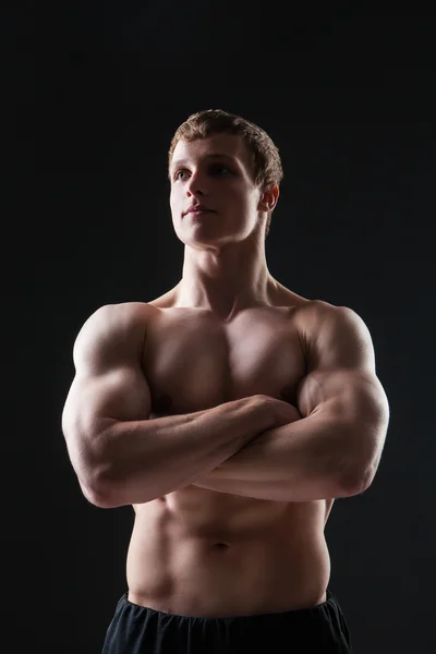 Muscular young man  shows the different movements and body parts — Stock Photo, Image