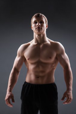 Kas genç adam farklı hareketleri ve vücut parçaları gösterir