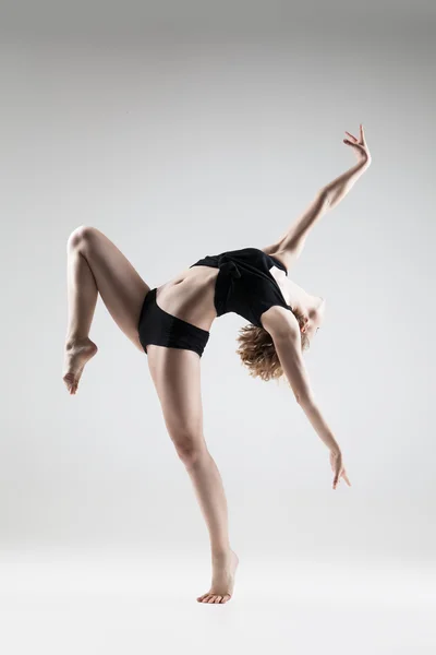 Young beautiful woman in black T-shirt and shorts dancing — Stock Photo, Image