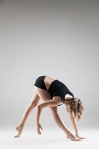 Young beautiful woman in black T-shirt and shorts dancing — Stock Photo, Image