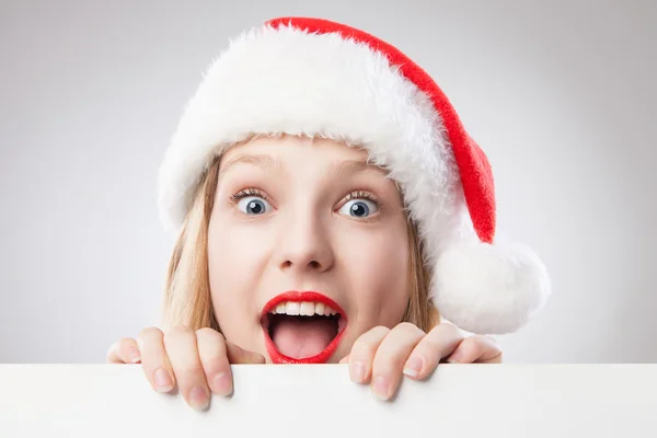 Christmas woman in santa hat holding empty board — Stock Photo, Image