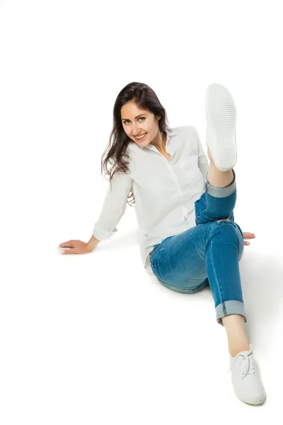 Sitting young woman in white shirt — Stock Photo, Image