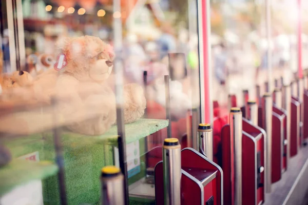 Claw machine in the amusement park of the mall which insert coin and press the control button to steel claw for pull up the doll, Skill crane or Teddy picker is game for play to fun.