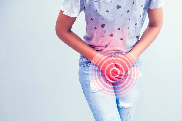 Young sick woman with hands holding pressing her crotch lower abdomen. Medical or gynecological problems, healthcare concept