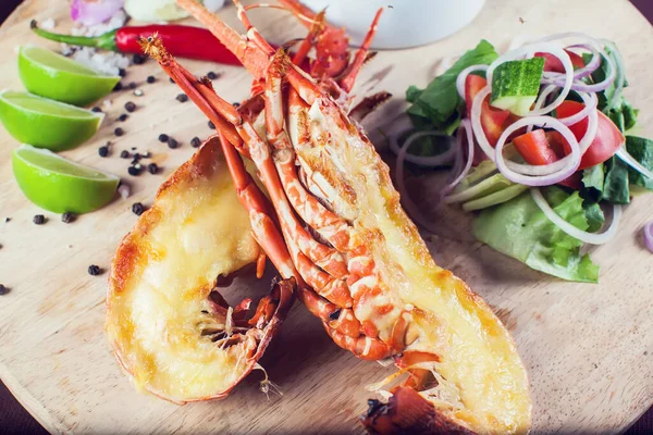 A luxury dish of lobster roasted and decorated with many items of vegetable
