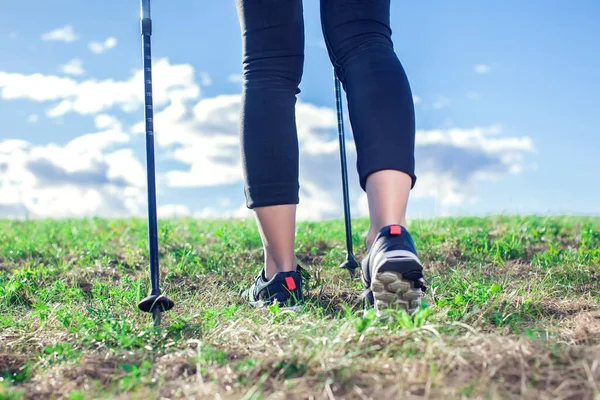 Nordic walking, exercise, sport, adventure, hiking concept -a woman hiking in the nature