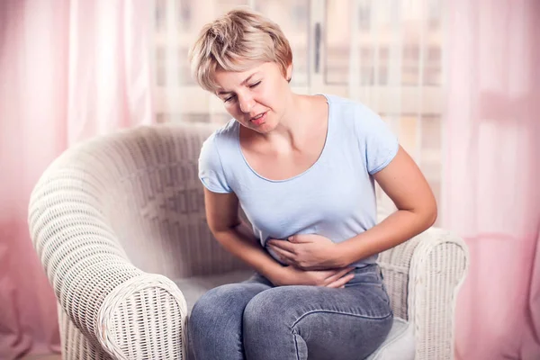 Woman feels strong stomach or period pain. People, healthcare and medicine concept