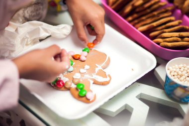 Çocuklar el yapımı kurabiyelerle geleneksel Noel süslemesi yapıyorlar.