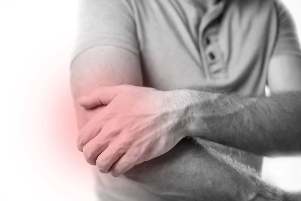 Male feels strong elbow pain isolated. People, healthcare and medicine concept