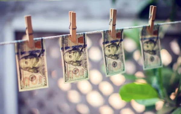 stock image US dollar banknotes hanging on rope for money laundering conept