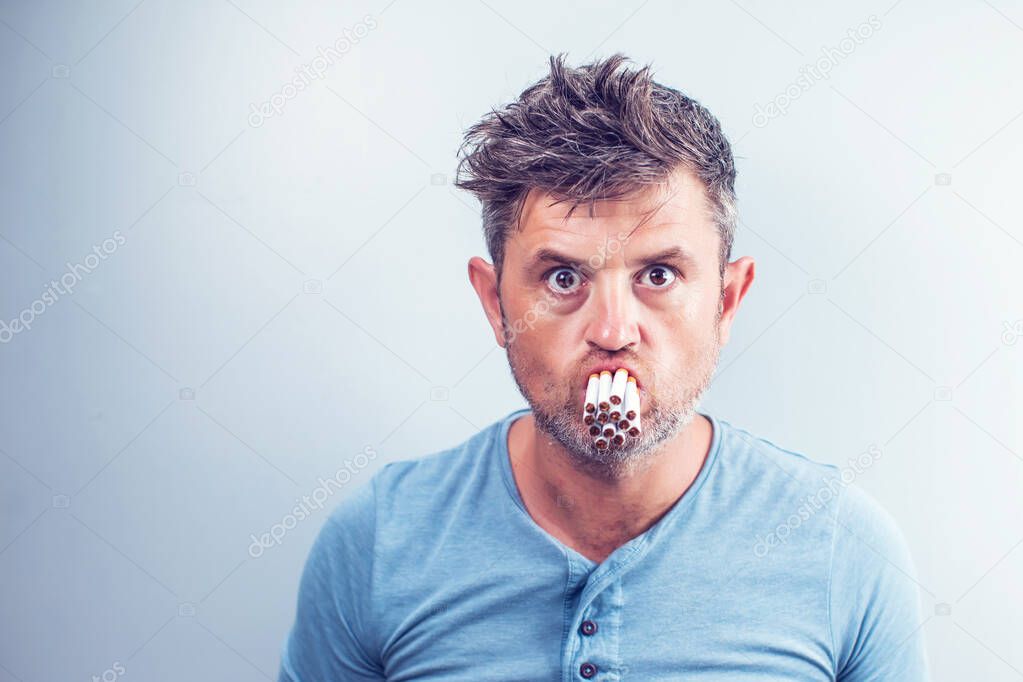 Young man with many cigarettes in his mouth