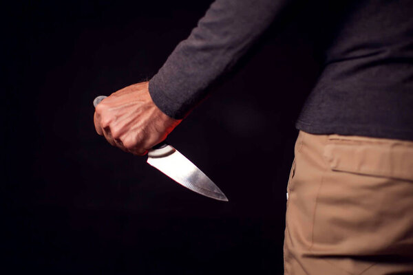 Man holds knife. People, family violence, crime concept