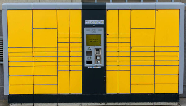 Yellow self-service post perminal machine or locker for parcel