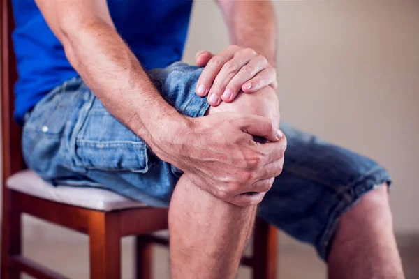 Close Man Sitting Holding His Knee Pain Due Injury White — Stock Photo, Image