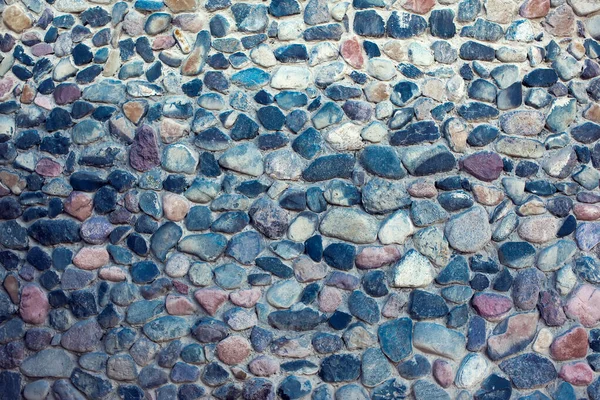 Natural colorful pebbles background on beach in summer for wall design and natural background concept in summer.