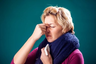 Woman with short blond hair got the flu and has a headache. People, healthcare and medicine concept