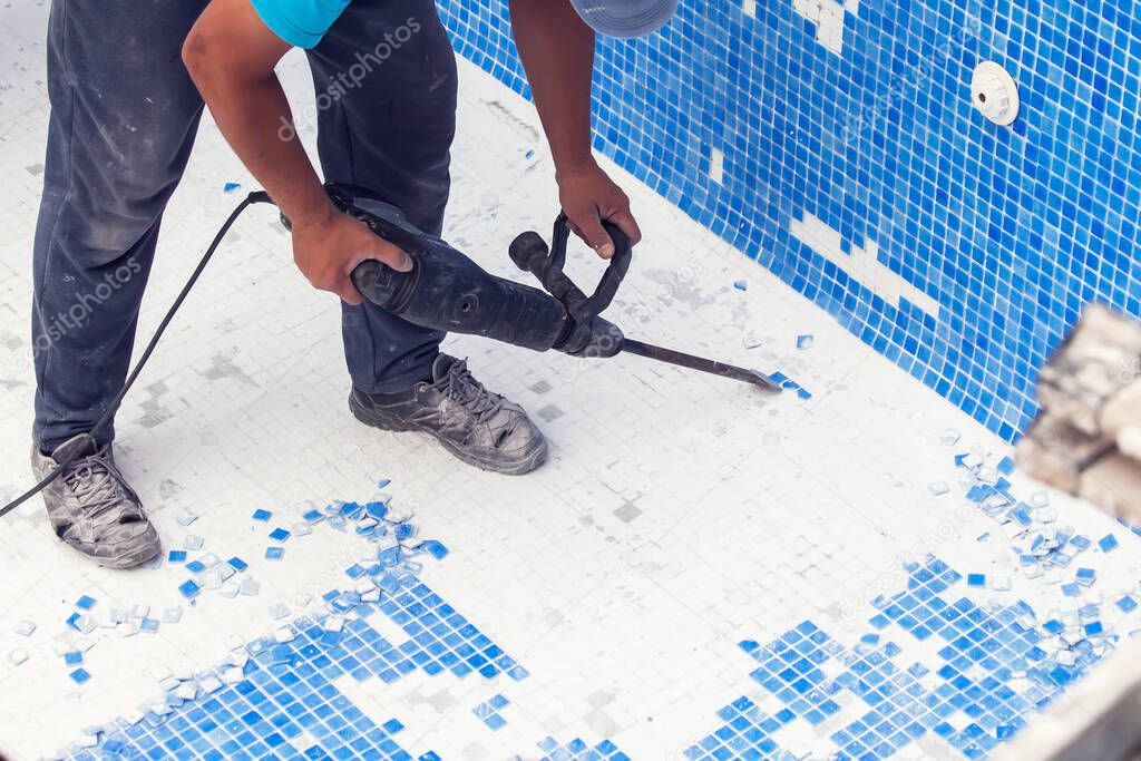 Removing tile in the pool, renovation work of swimming pool