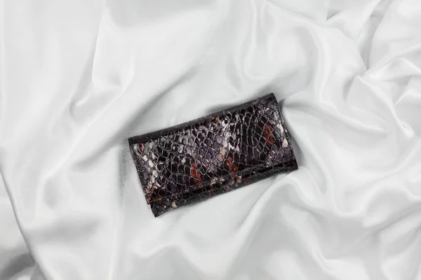 Purse lacquer on a white silk — Stock Photo, Image