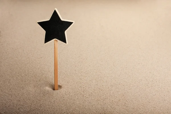 Pointer, ads board in the form star in the sand — Stock Photo, Image