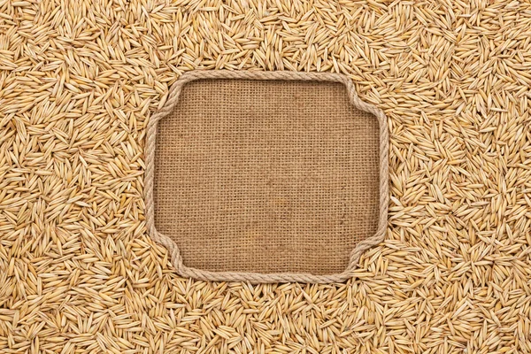 Figured frame made of rope with oat grains on sackcloth — Stock Photo, Image