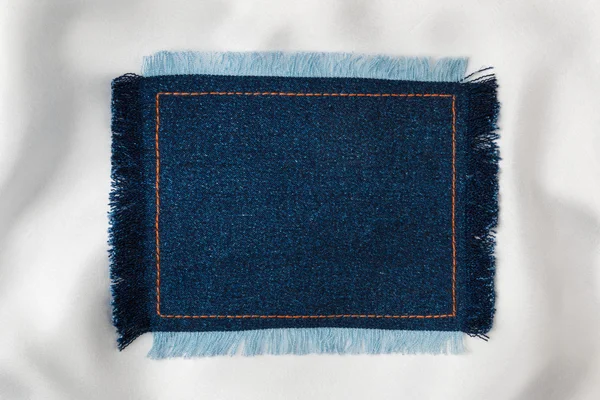 Ram för texten från en blå jeans tyg med sydda raderna i en orange tråd och kantas Royaltyfria Stockbilder
