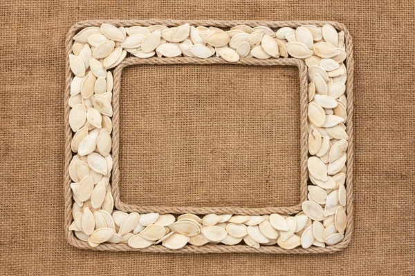 Two frame made of rope with pumpkin seeds on sackcloth