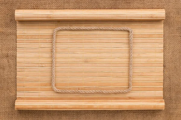 Frame made of rope lying on a bamboo mat in the form of manuscript — Stock Photo, Image
