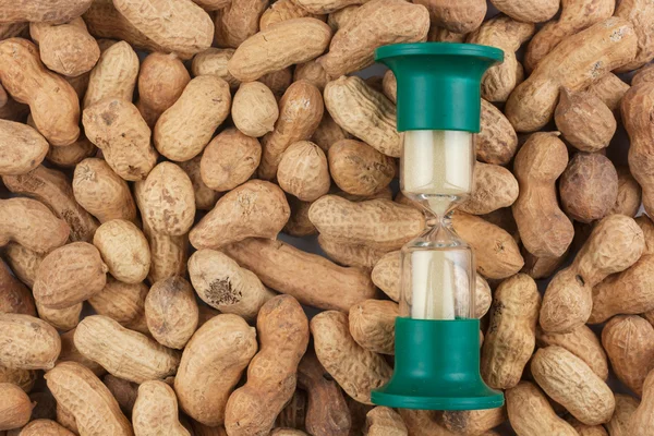 Hourglass and the peanut — Stock Photo, Image