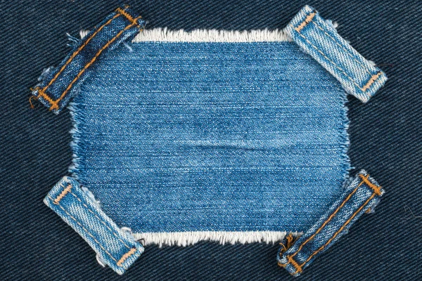 Frame with two straps jeans, lies on the blue denim — Stock Photo, Image