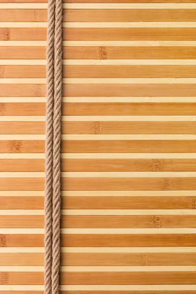 Frame of two smooth ropes lying on a bamboo mat — Stock Photo, Image