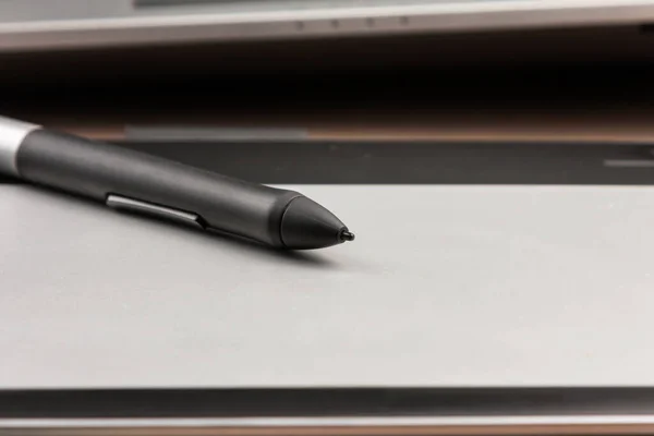 Close-up, stylus lying on a digital tablet for drawing and retouching. Technologies