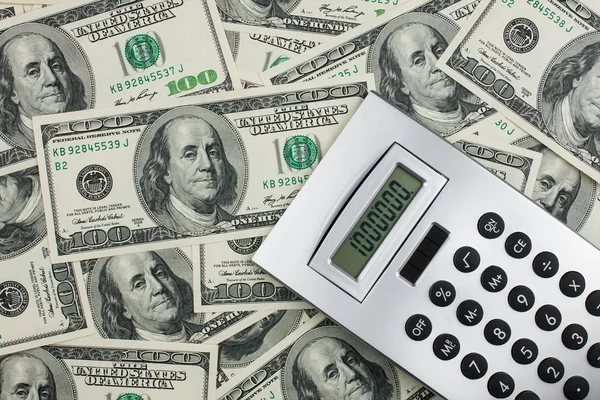 Calculator lies on a million dollars — Stock Photo, Image