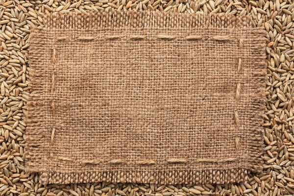 Frame of burlap  lying on a rye background — Stock Photo, Image