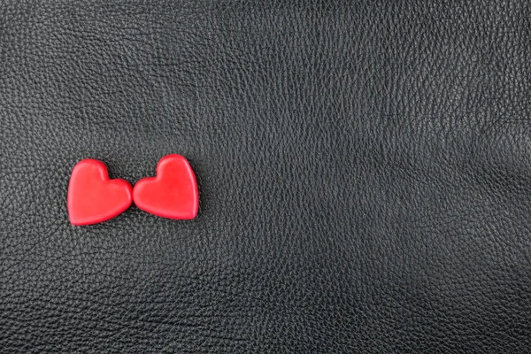 The concept of two lovers hearts lying on the natural leather — Stock Photo, Image