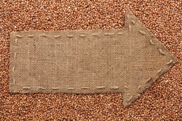 El puntero de la arpillera se encuentra en el grano de trigo sarraceno — Foto de Stock