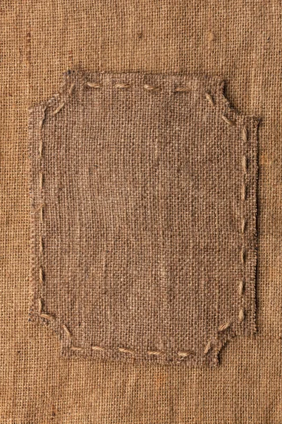 Frame of burlap, lies on a background of burlap — Stok Foto