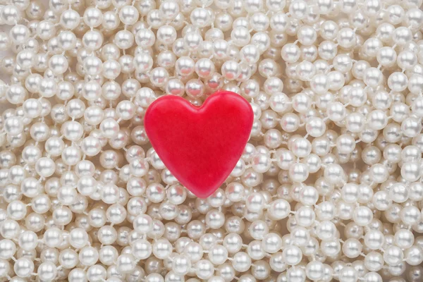 Hearts lying on the white beads — Stock Photo, Image