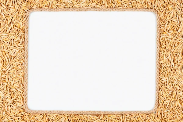 Frame made of rope with  oats  lying on a white background — Stock Photo, Image