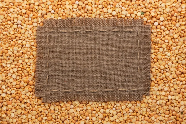 Frame made of burlap with the line lies on  peas seeds