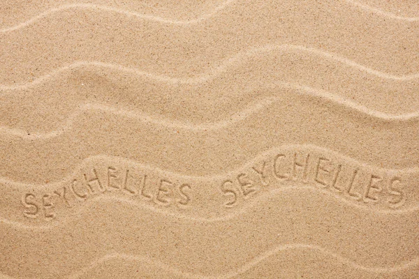 Inscripción de Seychelles en la arena ondulada — Foto de Stock