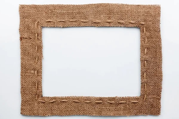 Frame of burlap, lies on a white background — Stock Photo, Image