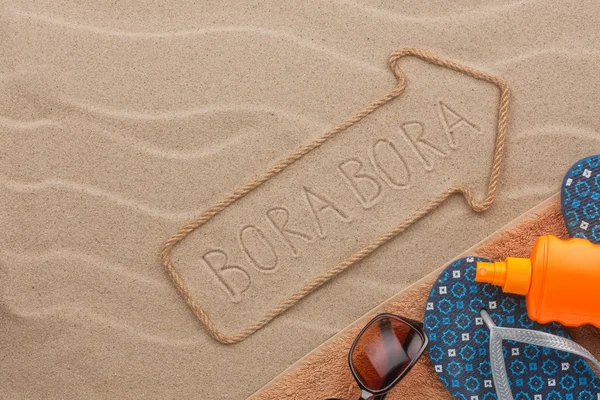 Bora Bora  pointer and beach accessories lying on the sand — Stock Photo, Image