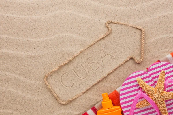 Cuba  pointer and beach accessories lying on the sand — Stock Photo, Image