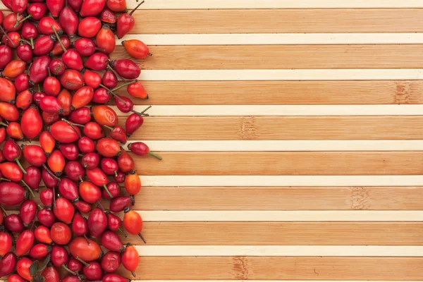 Rosehip on a bamboo mat — Stock Photo, Image