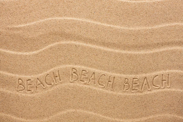 Beach inscription on the wavy sand — Stock Photo, Image