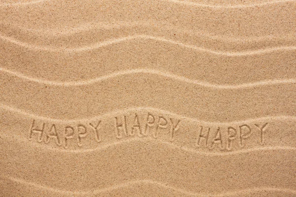 Happy inscription on the wavy sand — Stock Photo, Image