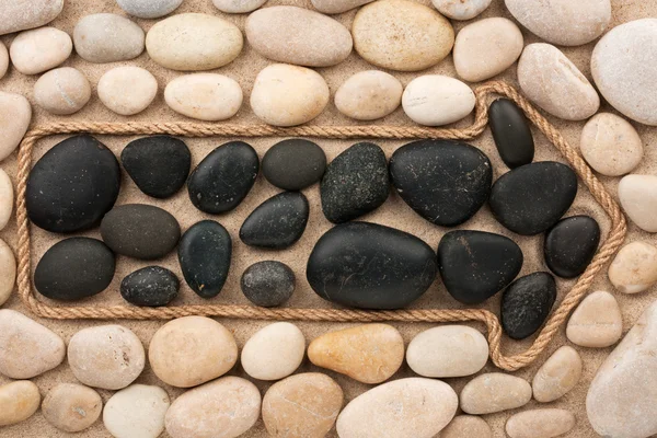 Pointer made of rope with white and black stones — Stock Photo, Image