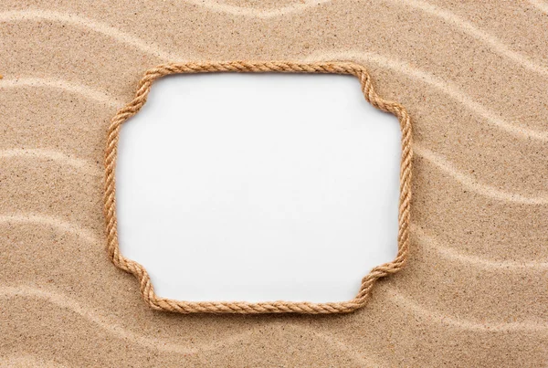 Frame made of rope with a white background on the sand — Stock Photo, Image