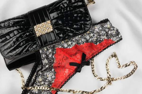 Beautiful lingerie and a bag with a chain in the form of heart l — Stock Photo, Image