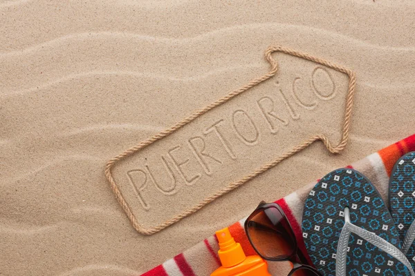 Puerto Rico  pointer and beach accessories lying on the sand — Stock Photo, Image